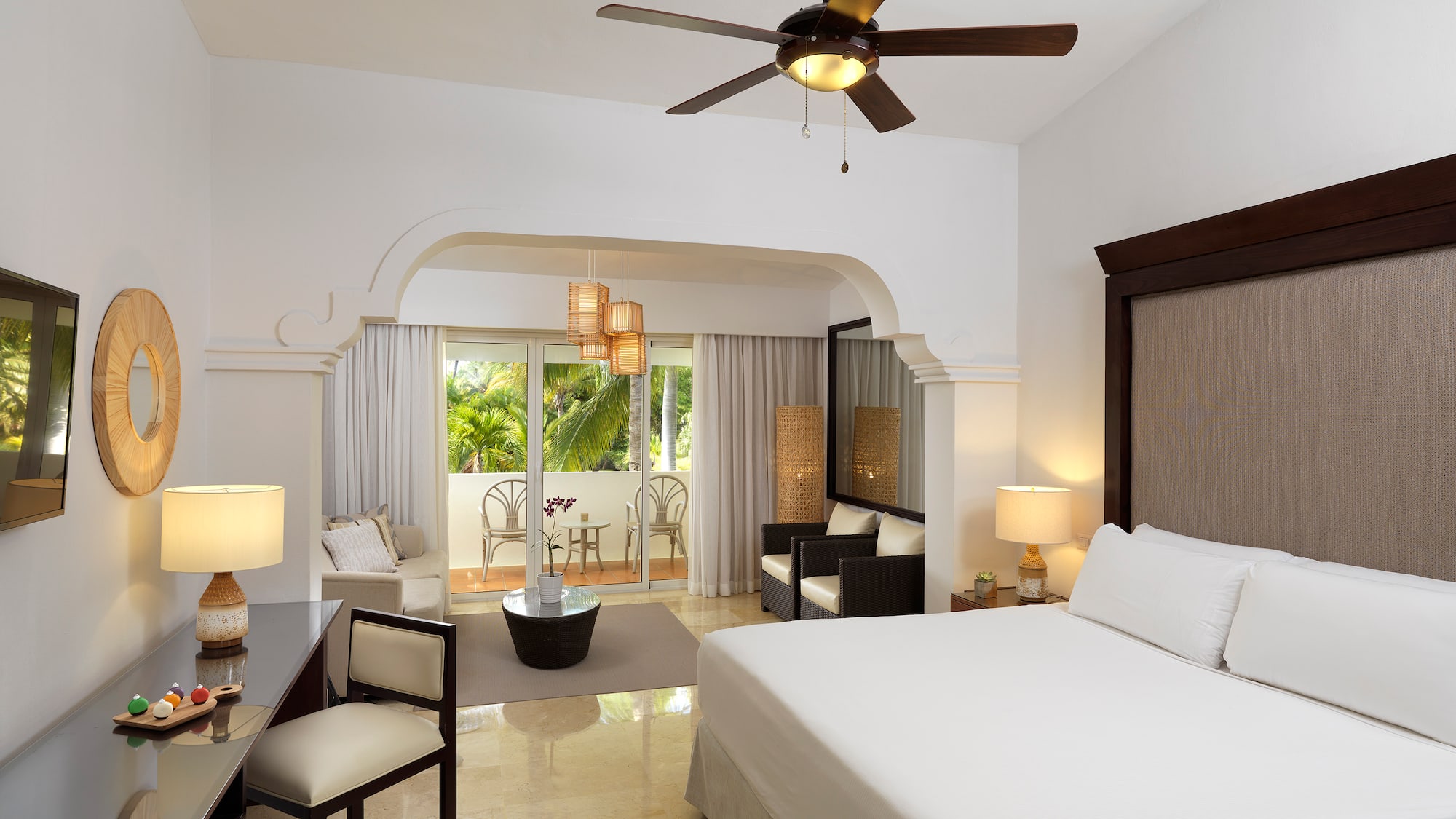 a room with a bed and a ceiling fan