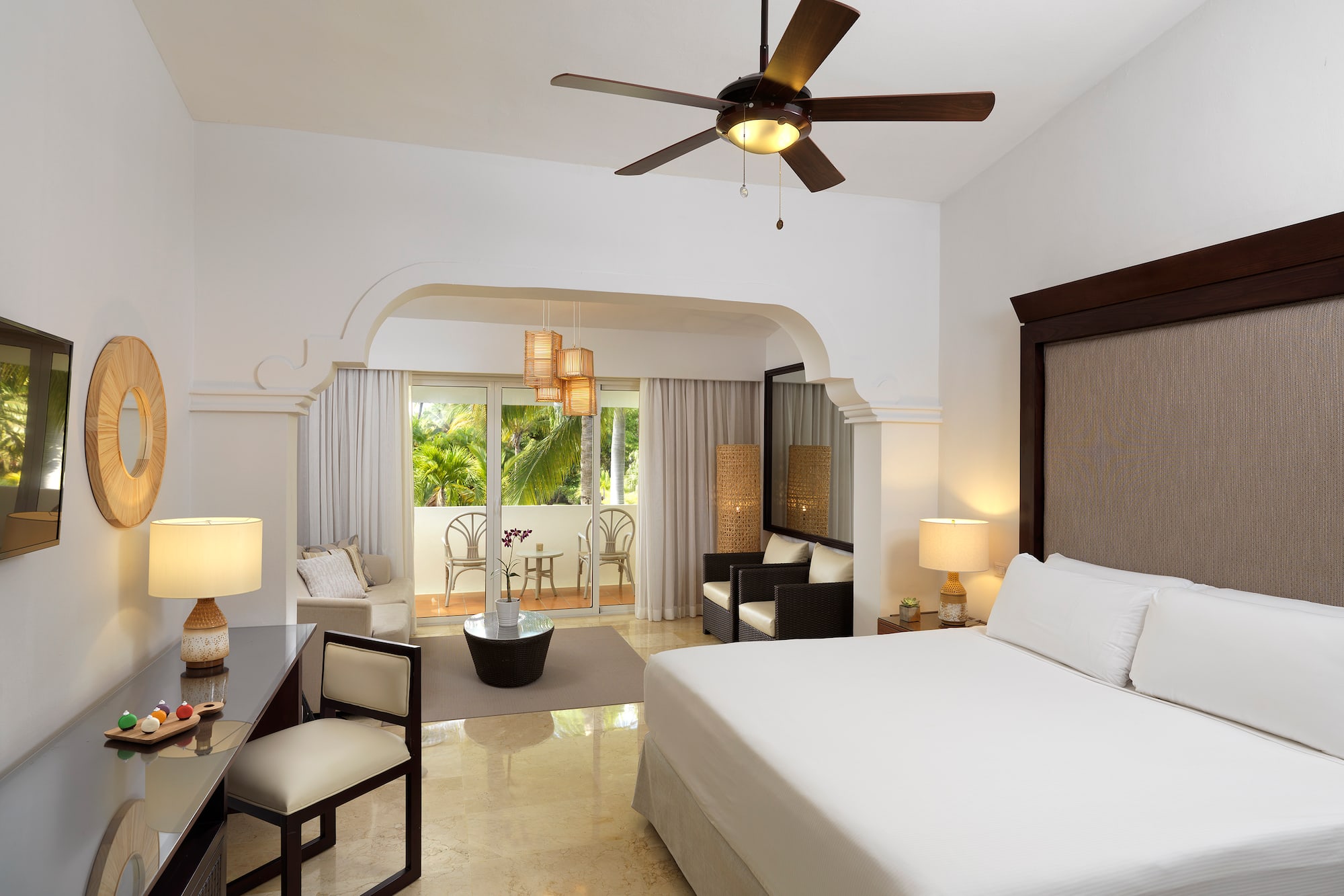 a room with a bed and a ceiling fan