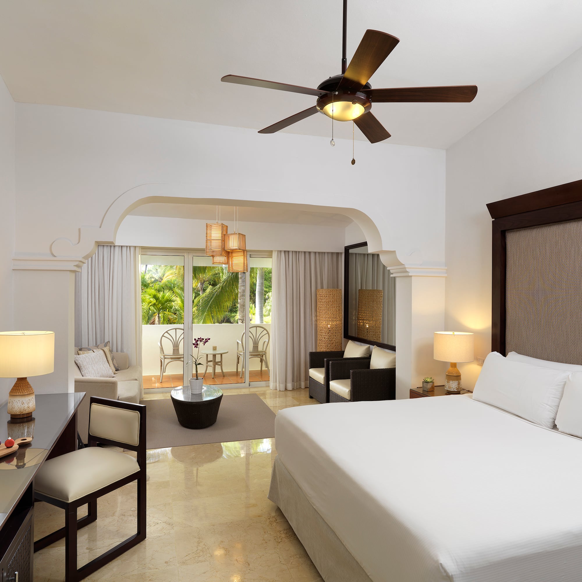 a room with a bed and a ceiling fan