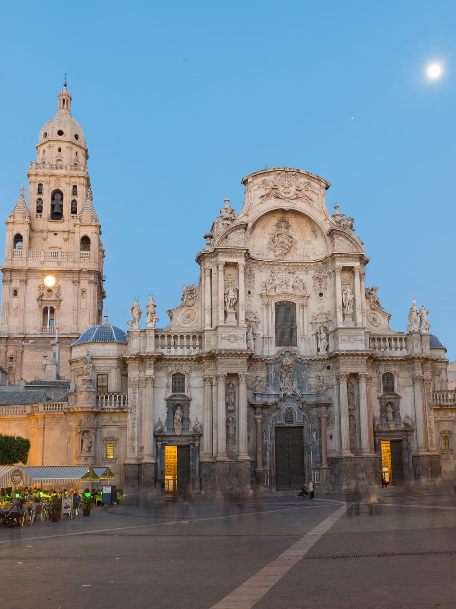 a large building with a clock tower with Cathedral of Murcia in the background