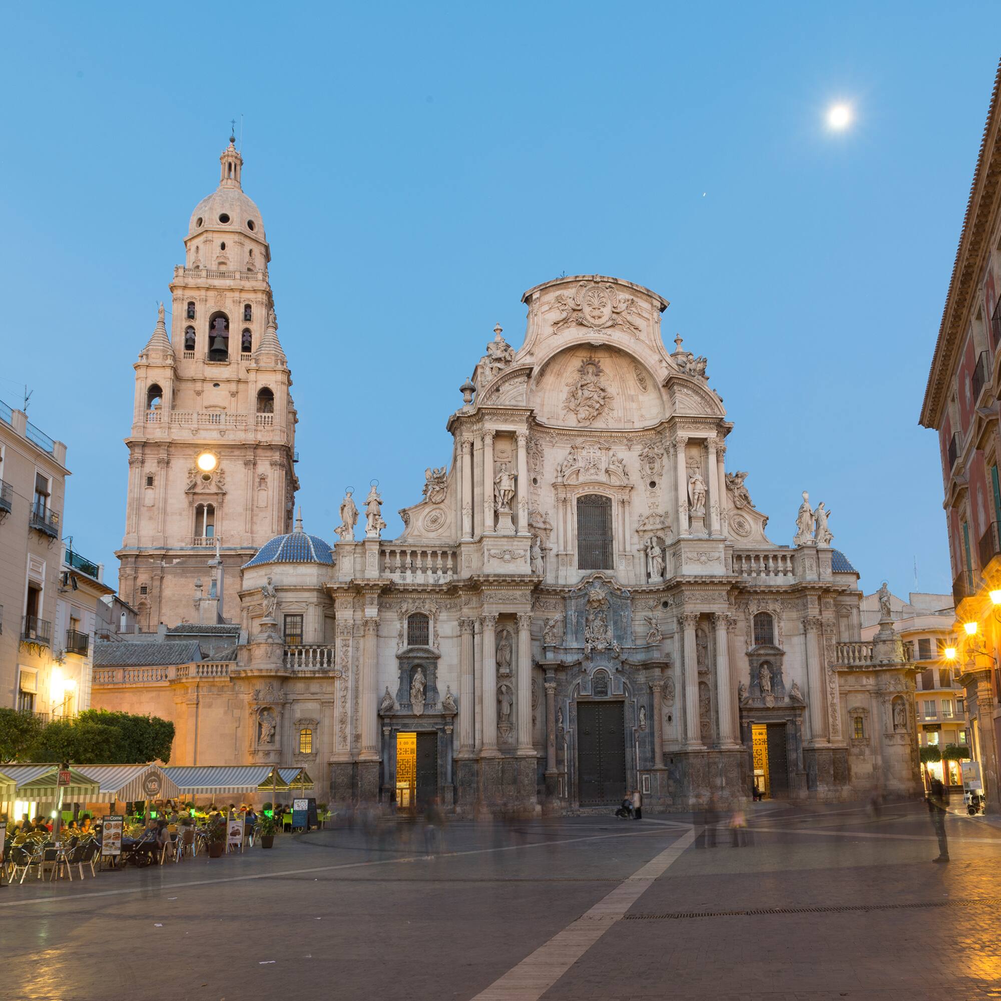 a large building with a clock tower with Cathedral of Murcia in the background