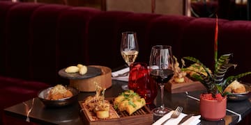 a table with food and wine glasses