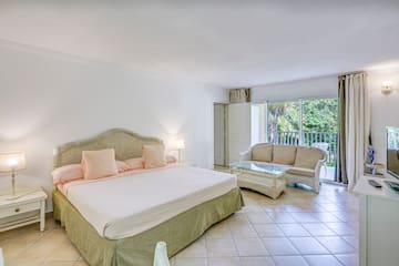 a bedroom with a bed and a couch