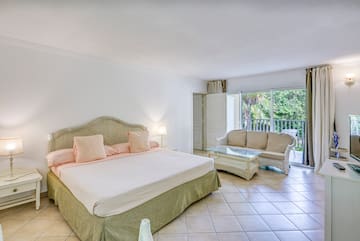 a bedroom with a bed and a couch
