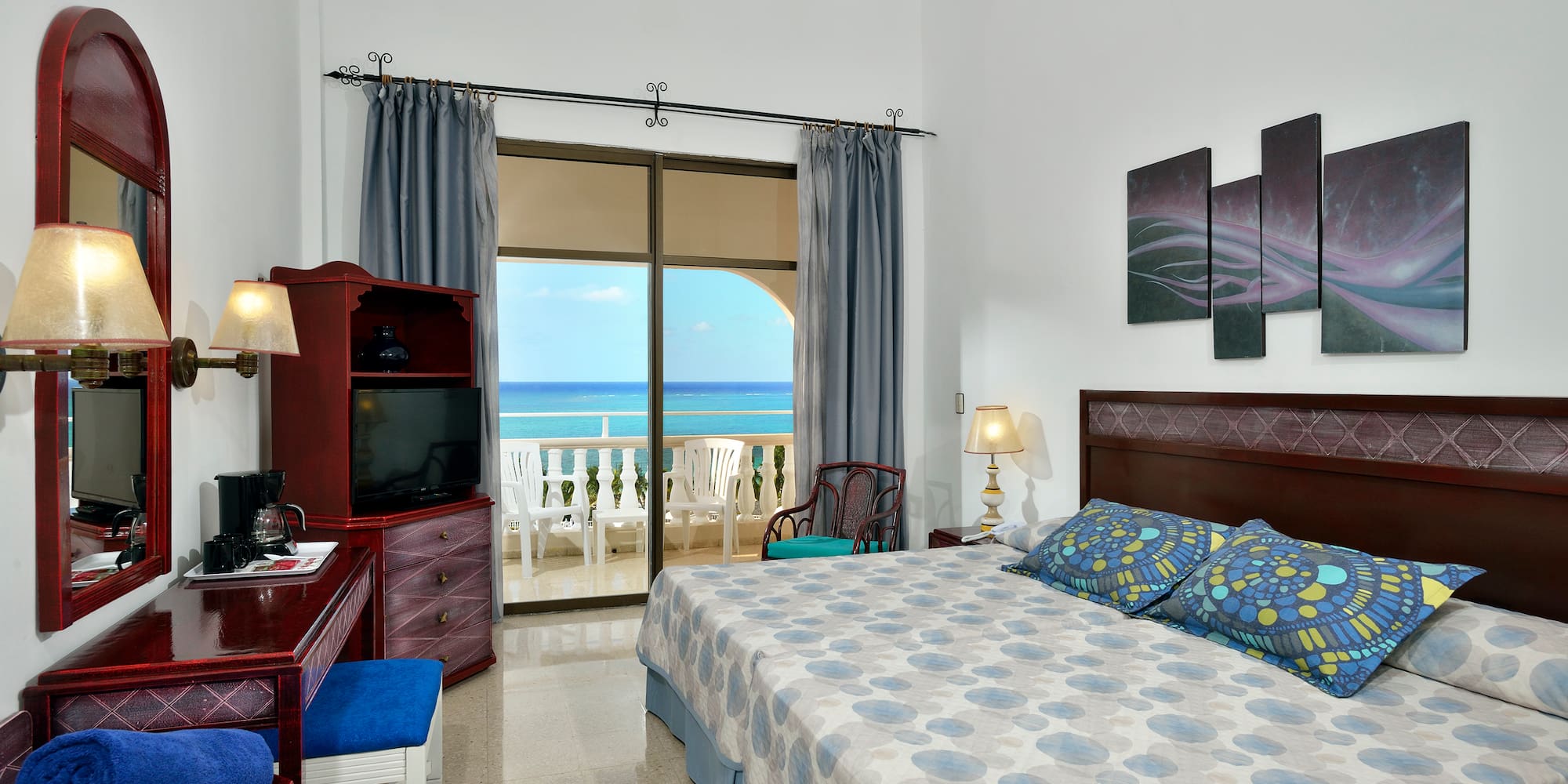 a bedroom with a large bed and a television