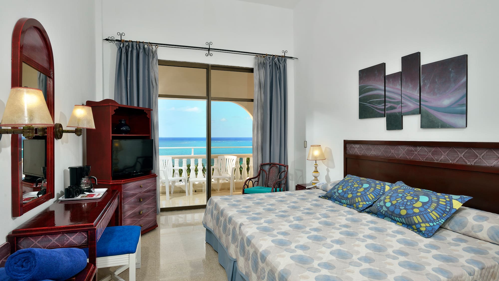 a bedroom with a large bed and a television