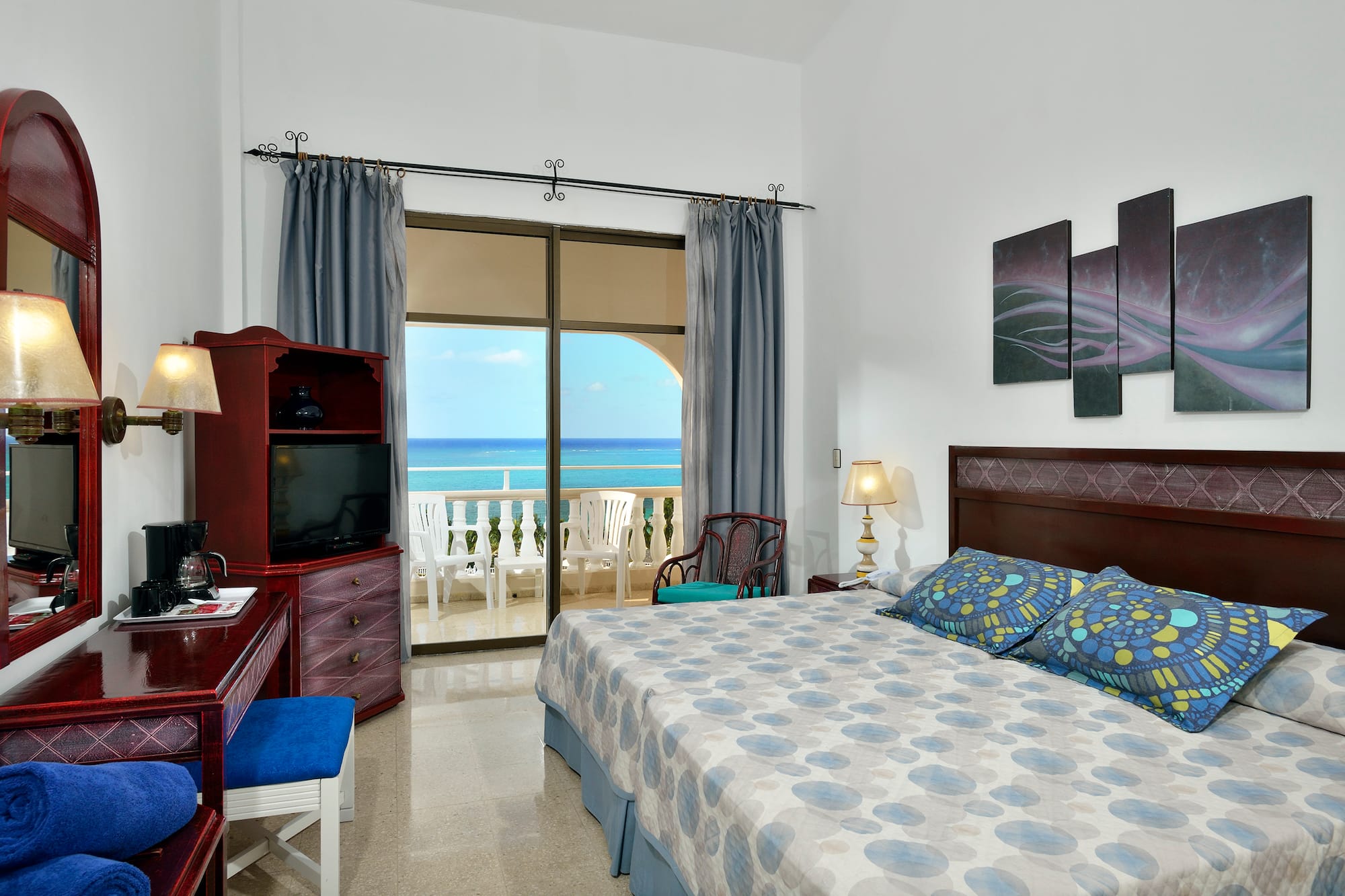 a bedroom with a large bed and a television