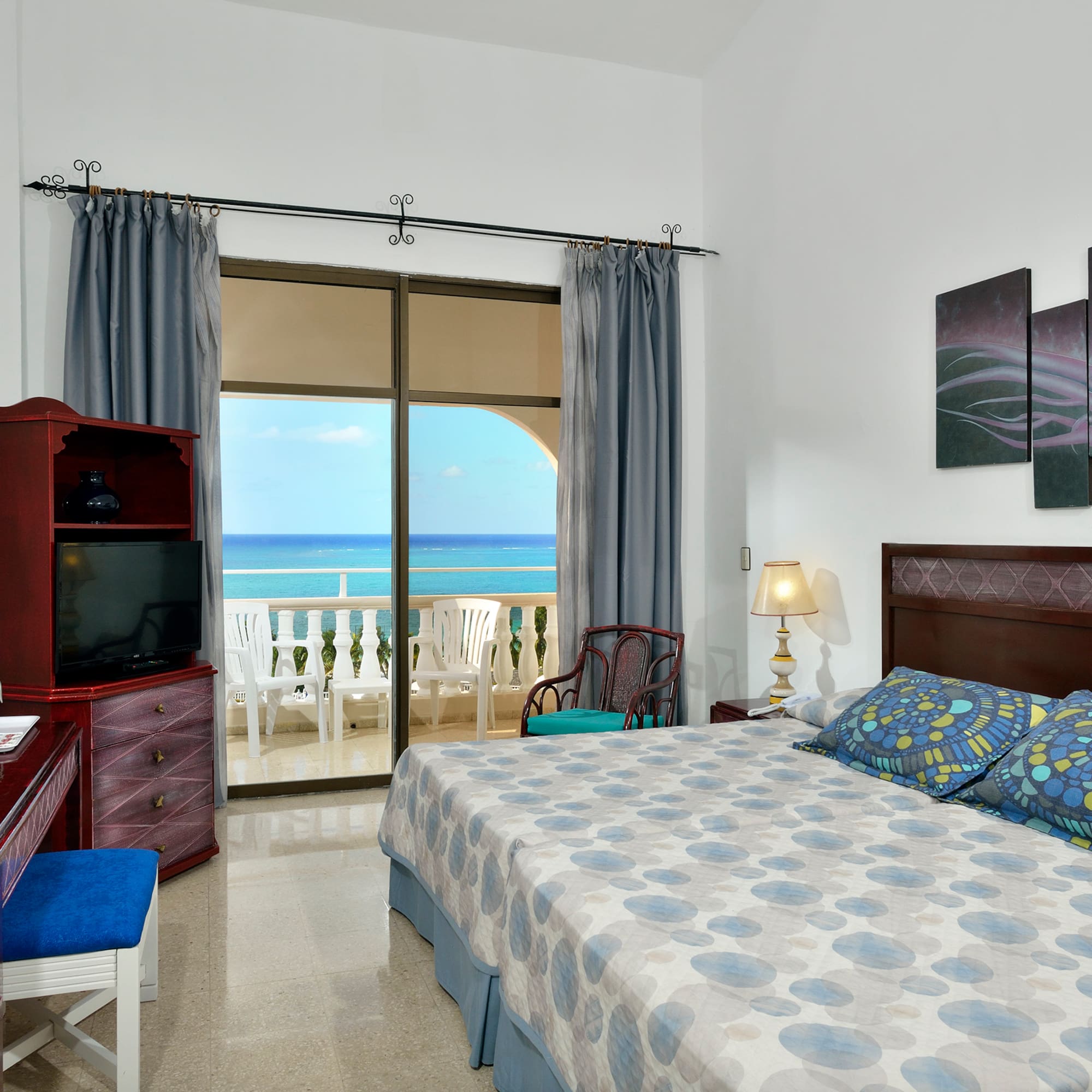 a bedroom with a large bed and a television