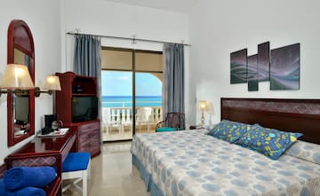 a bedroom with a large bed and a television