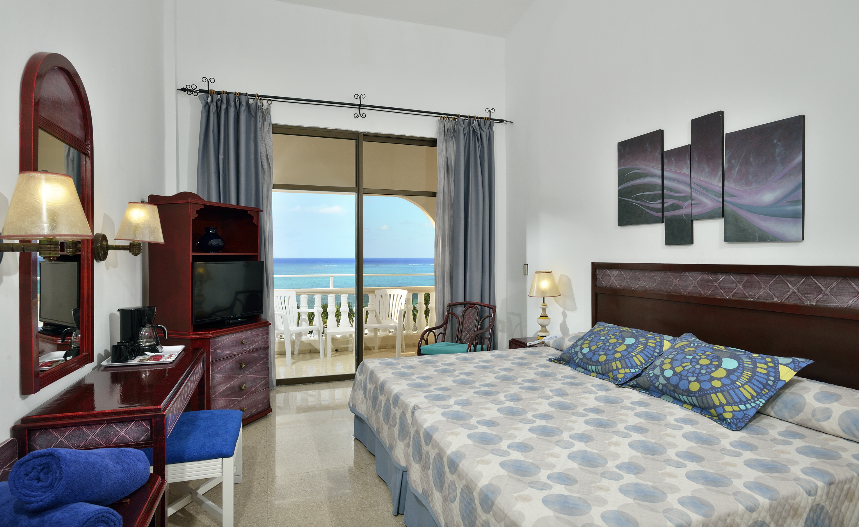 a bedroom with a large bed and a television