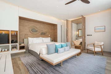 a bedroom with a bed and a fan