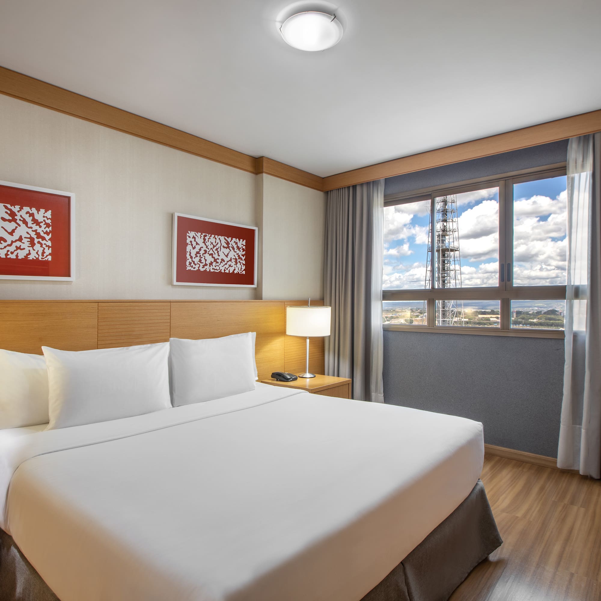 a bedroom with a bed and a lamp