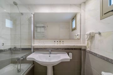 a bathroom with a sink and shower