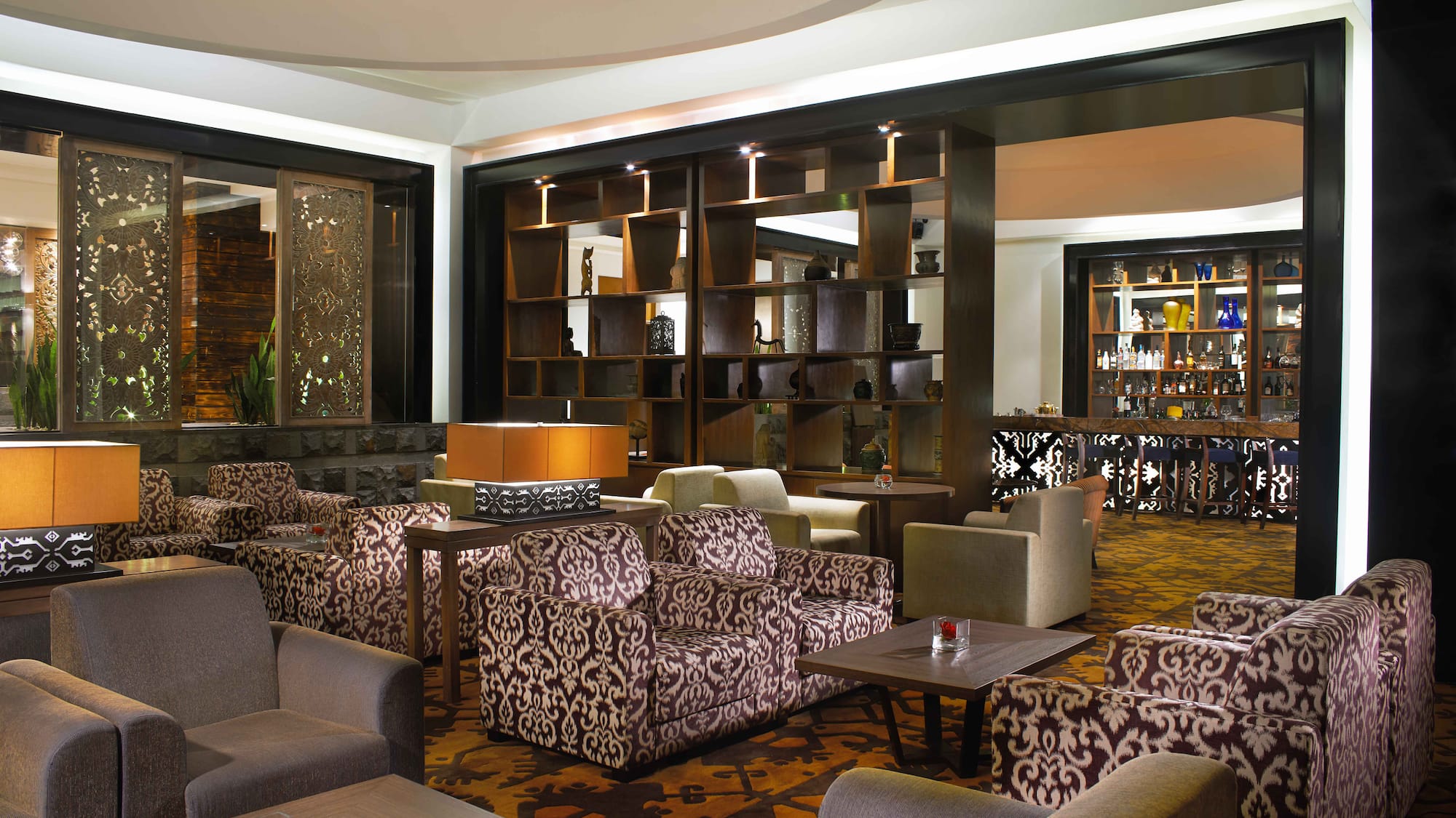 a room with a large wall and chairs