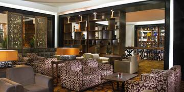 a room with a large wall and chairs