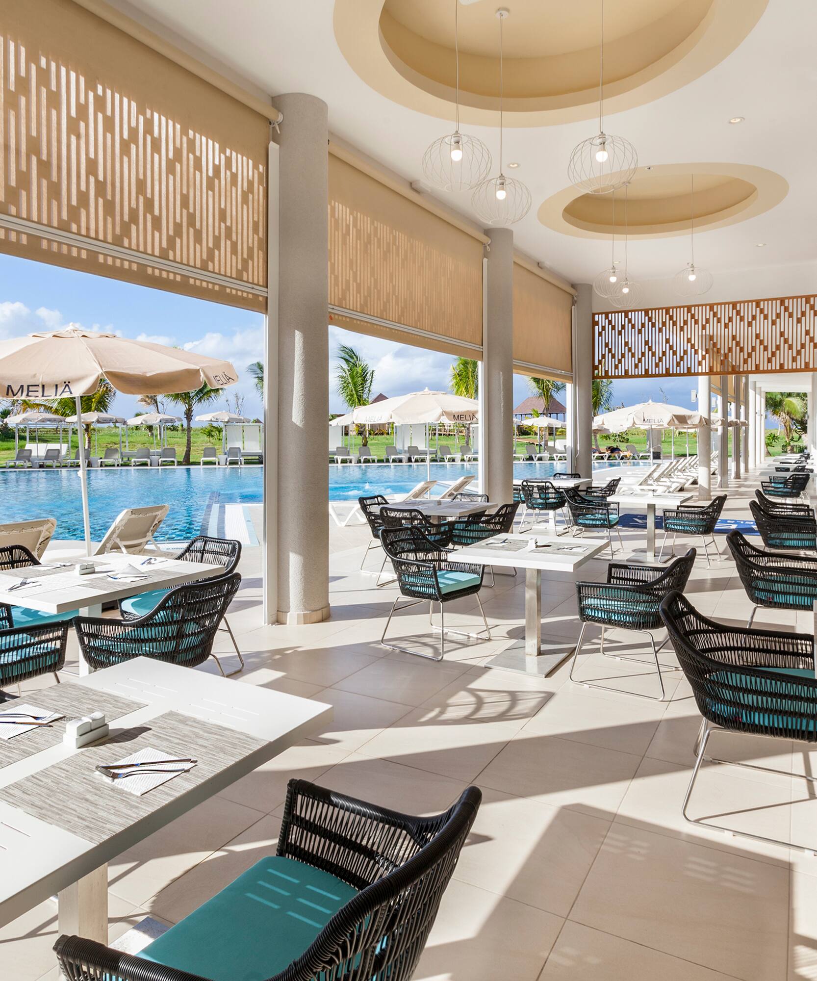 a pool with tables and chairs