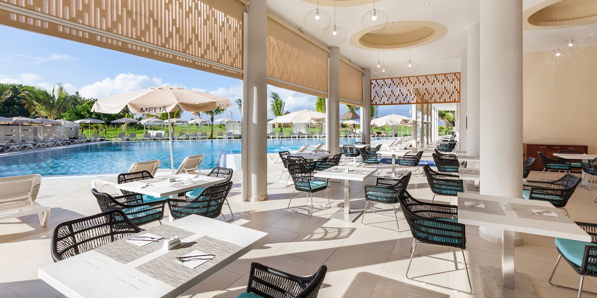 a pool with tables and chairs
