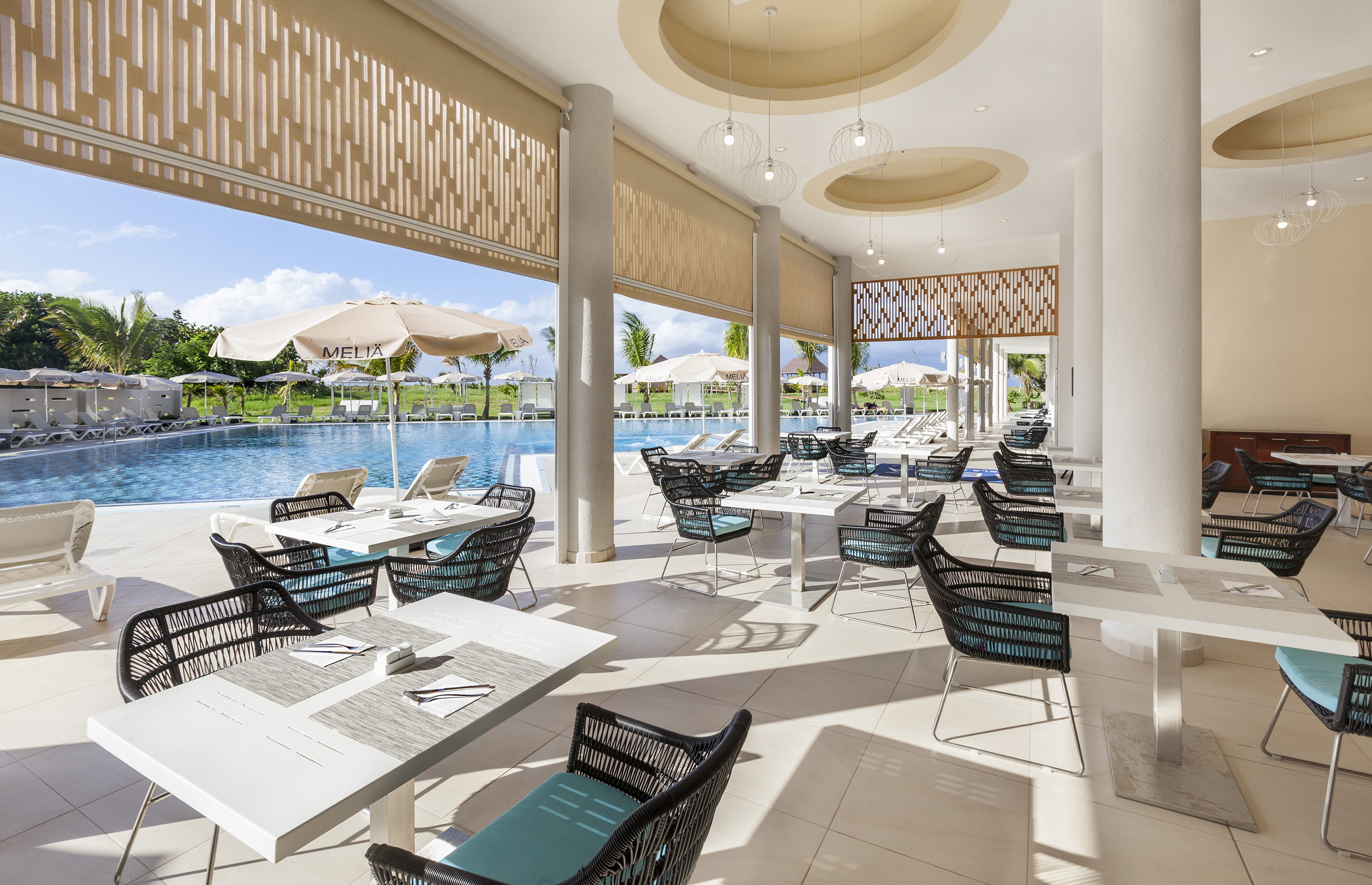 a pool with tables and chairs