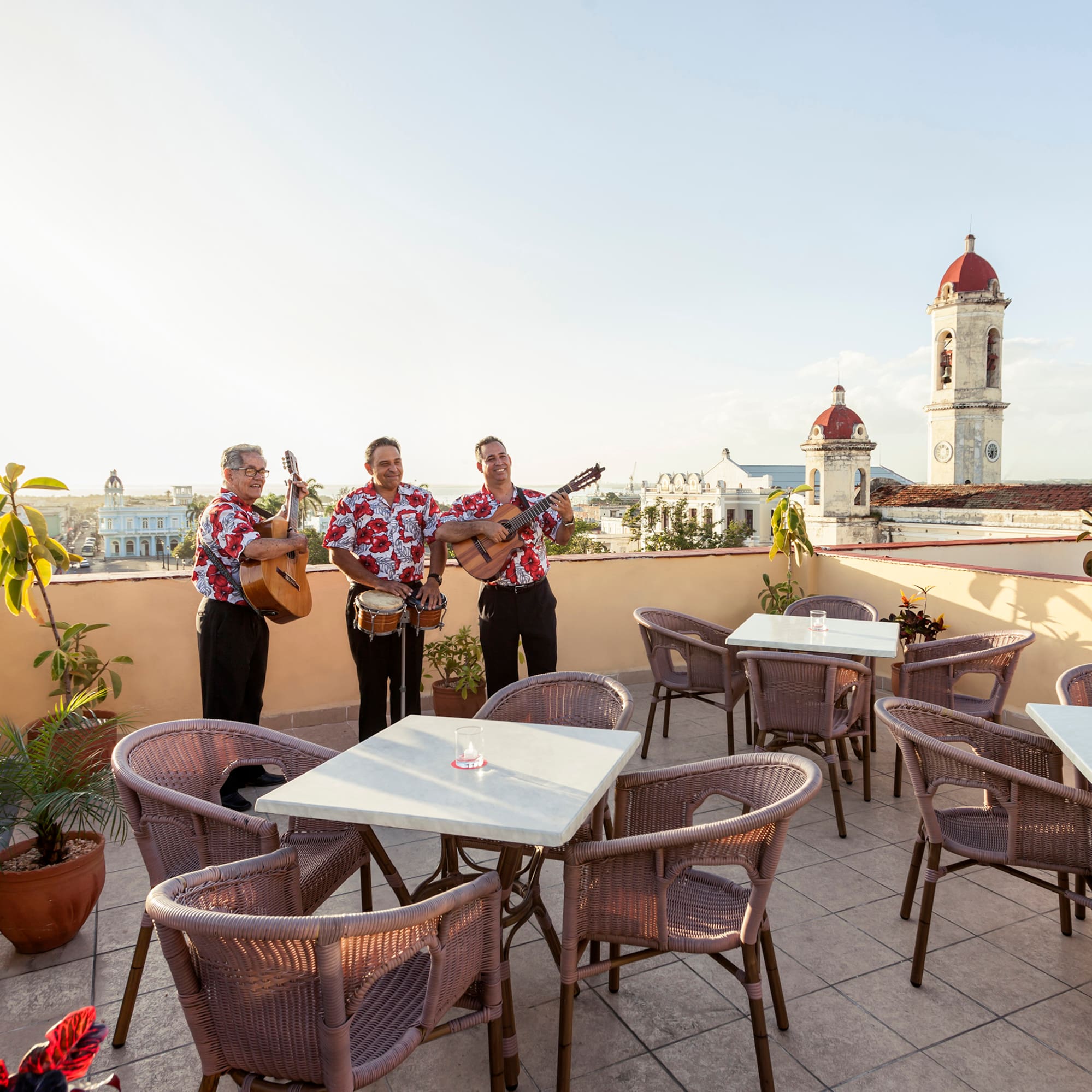 a group of men playing instruments on a rooftop