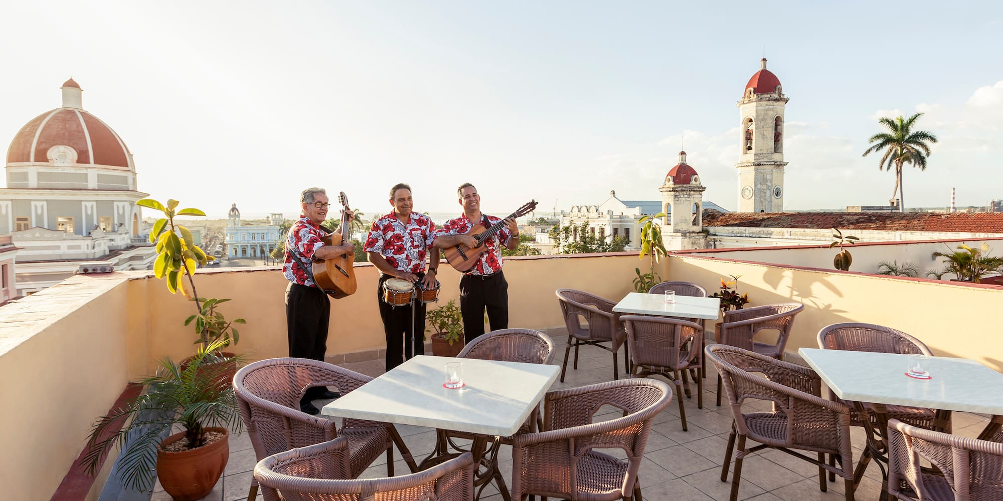 a group of men playing instruments on a rooftop