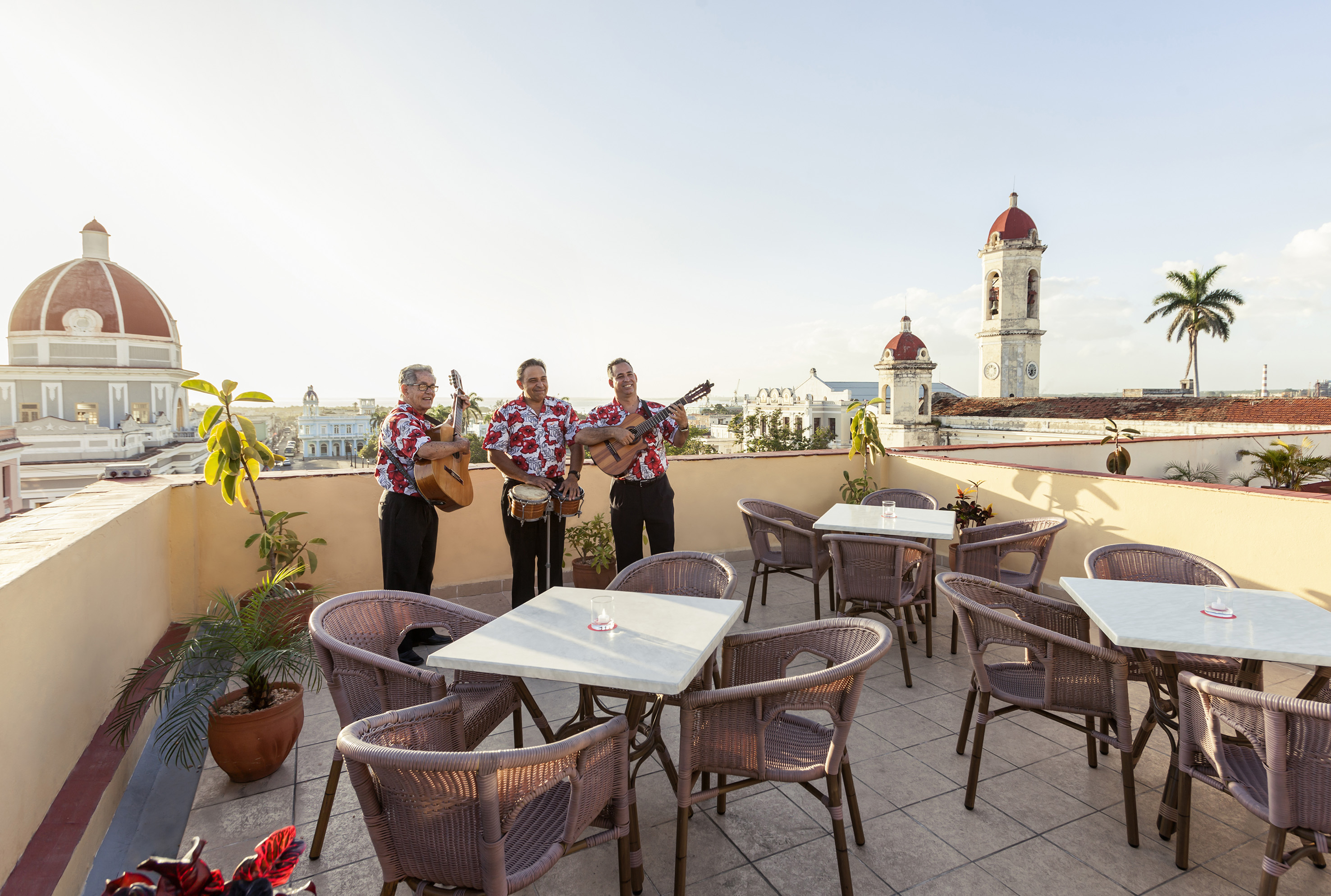 a group of men playing instruments on a rooftop
