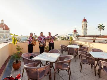 a group of men playing instruments on a rooftop