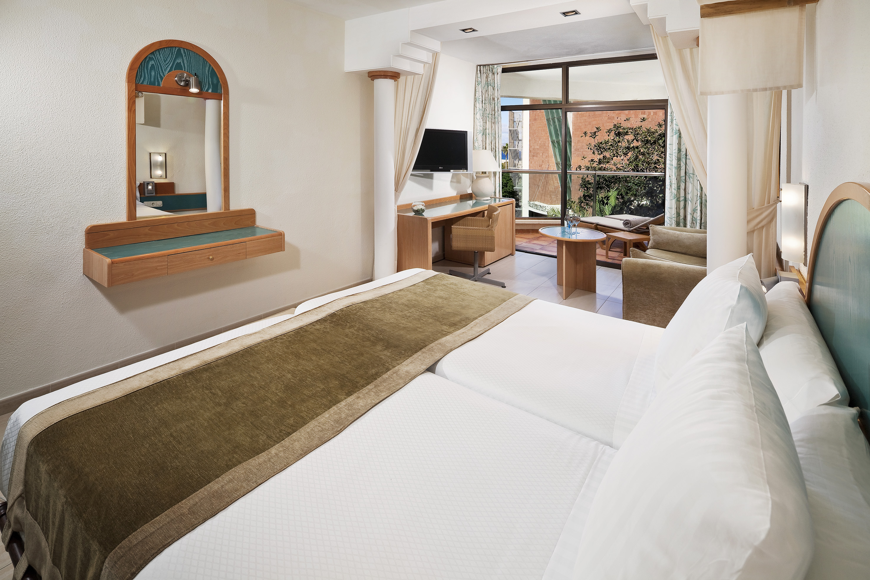 a room with a bed and a mirror