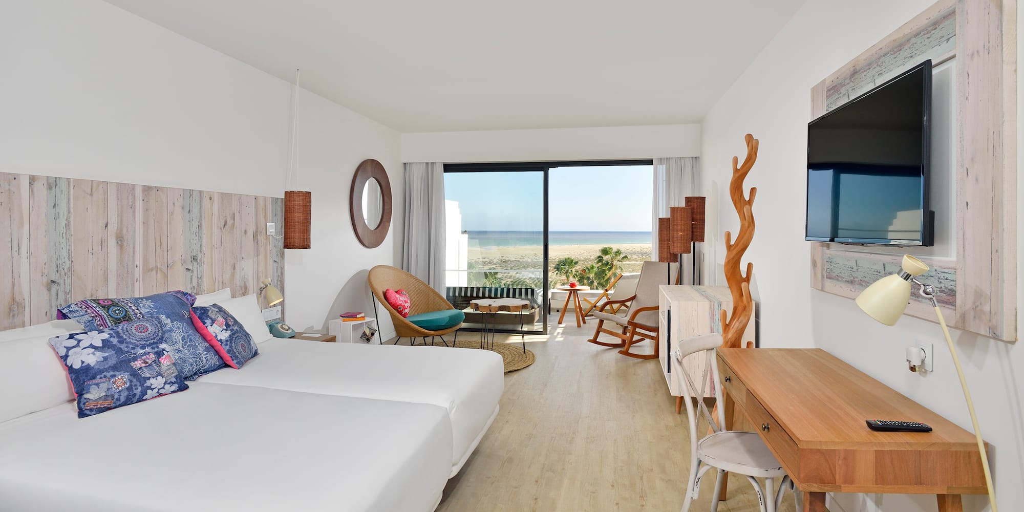 a room with two beds and a television