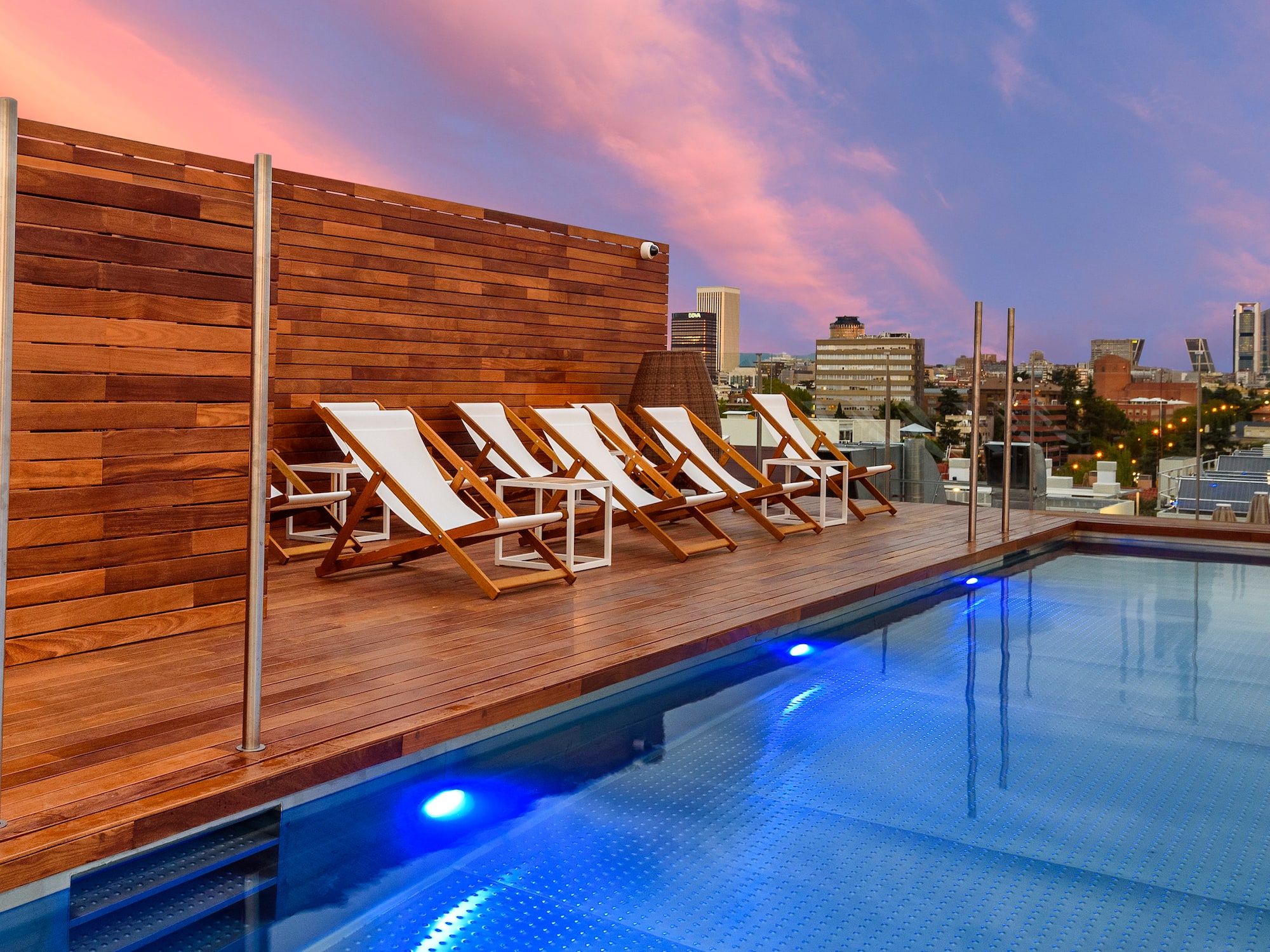 a pool with chairs on the deck