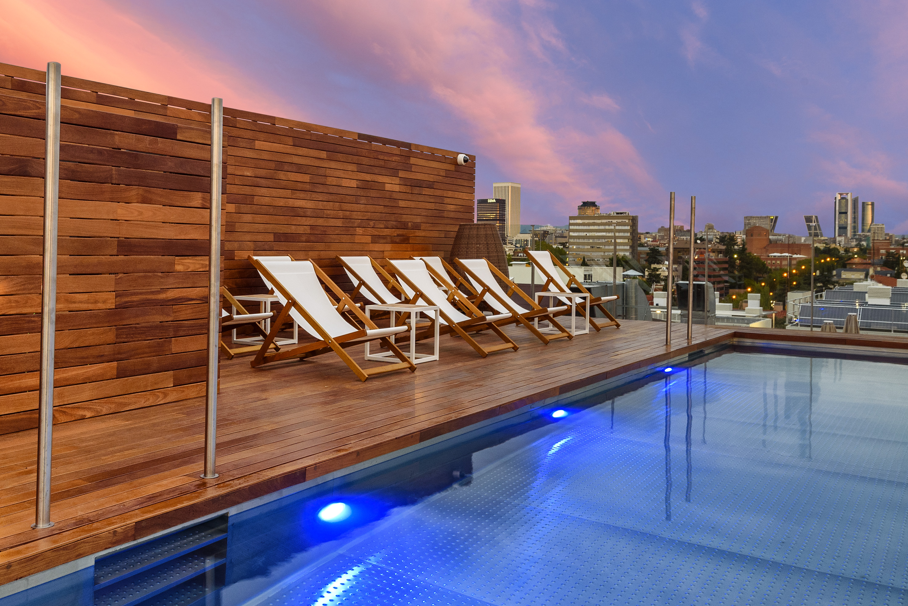 a pool with chairs on the deck