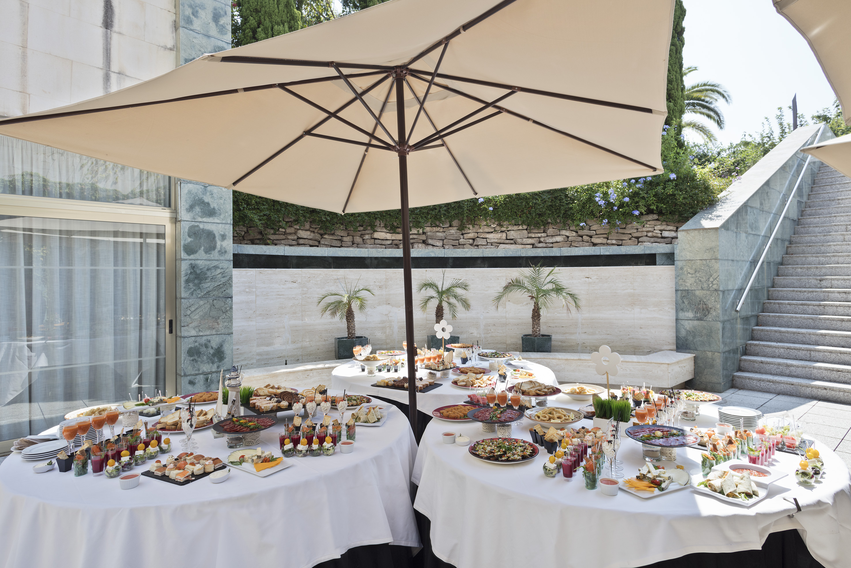 Outdoor buffet spread with appetizers and drinks for a catering event.