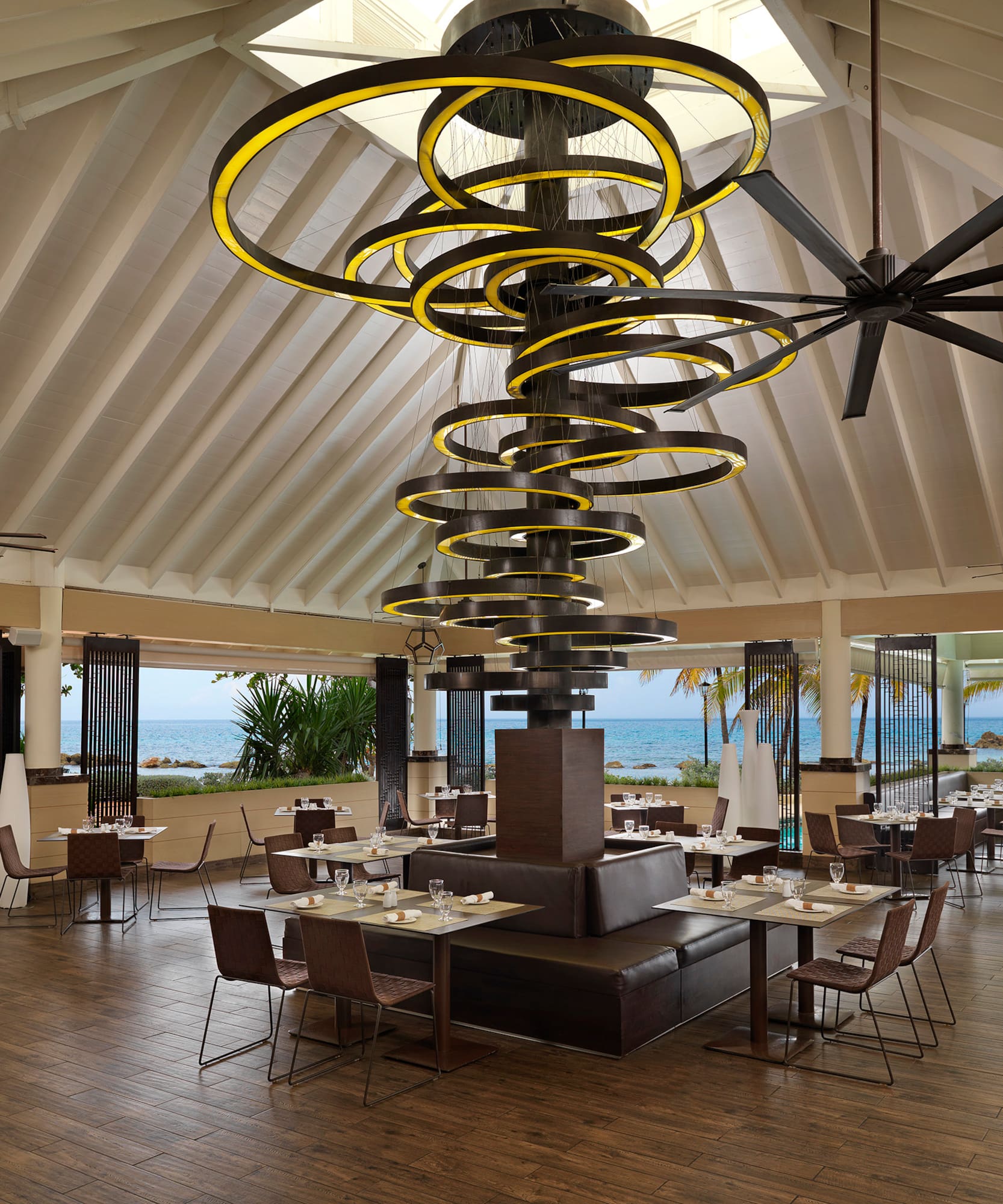 a large room with a large chandelier and chairs