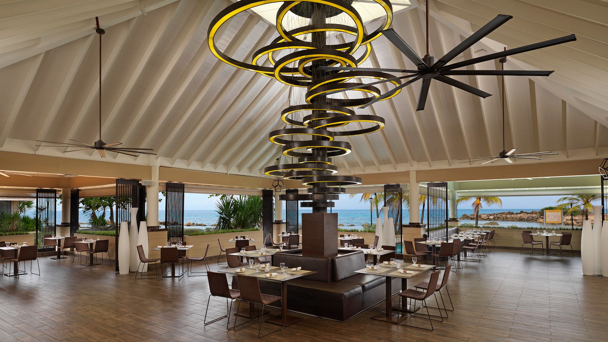 a large room with a large chandelier and chairs