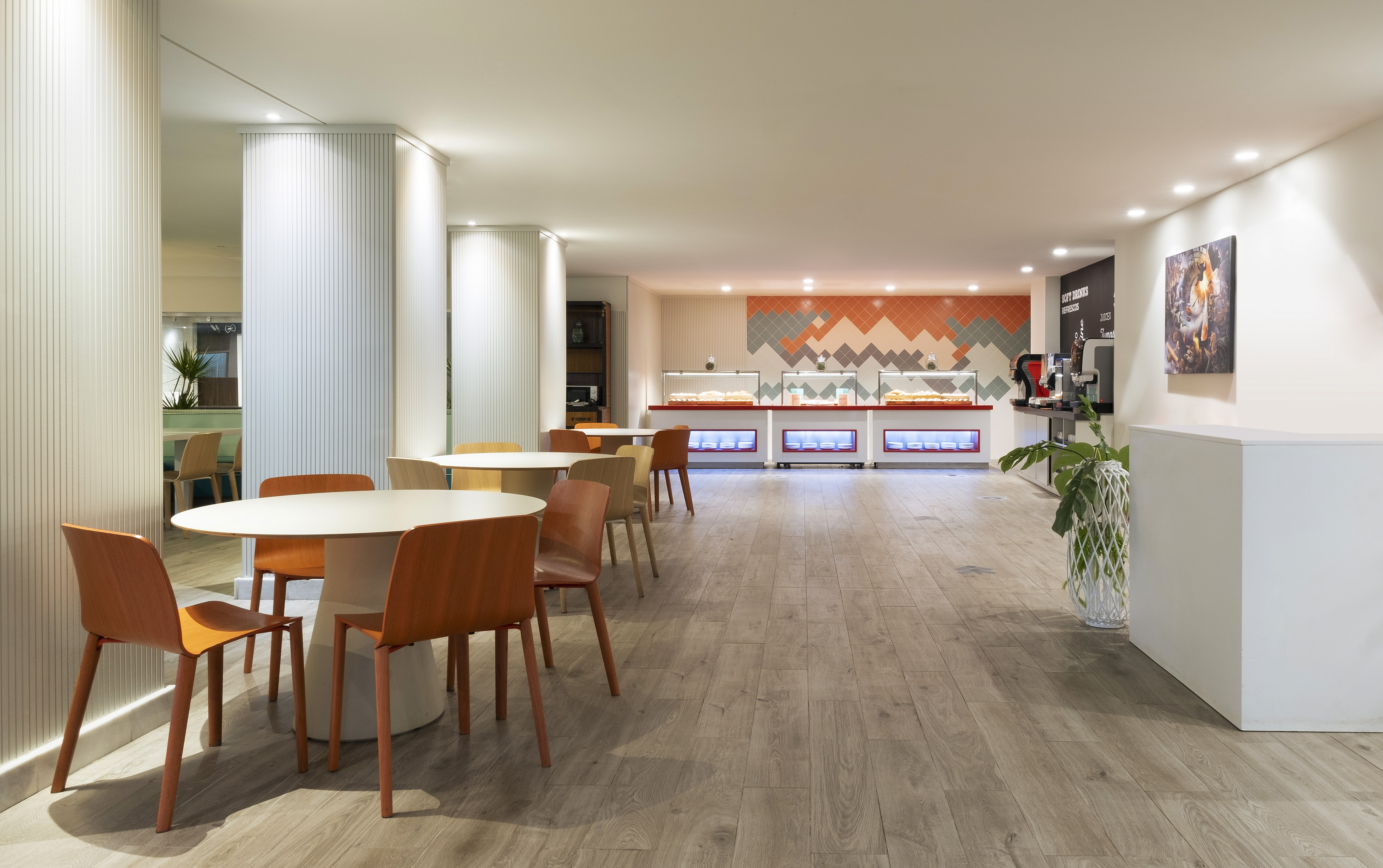 Bright modern buffet dining area with seating and self-service food stations.