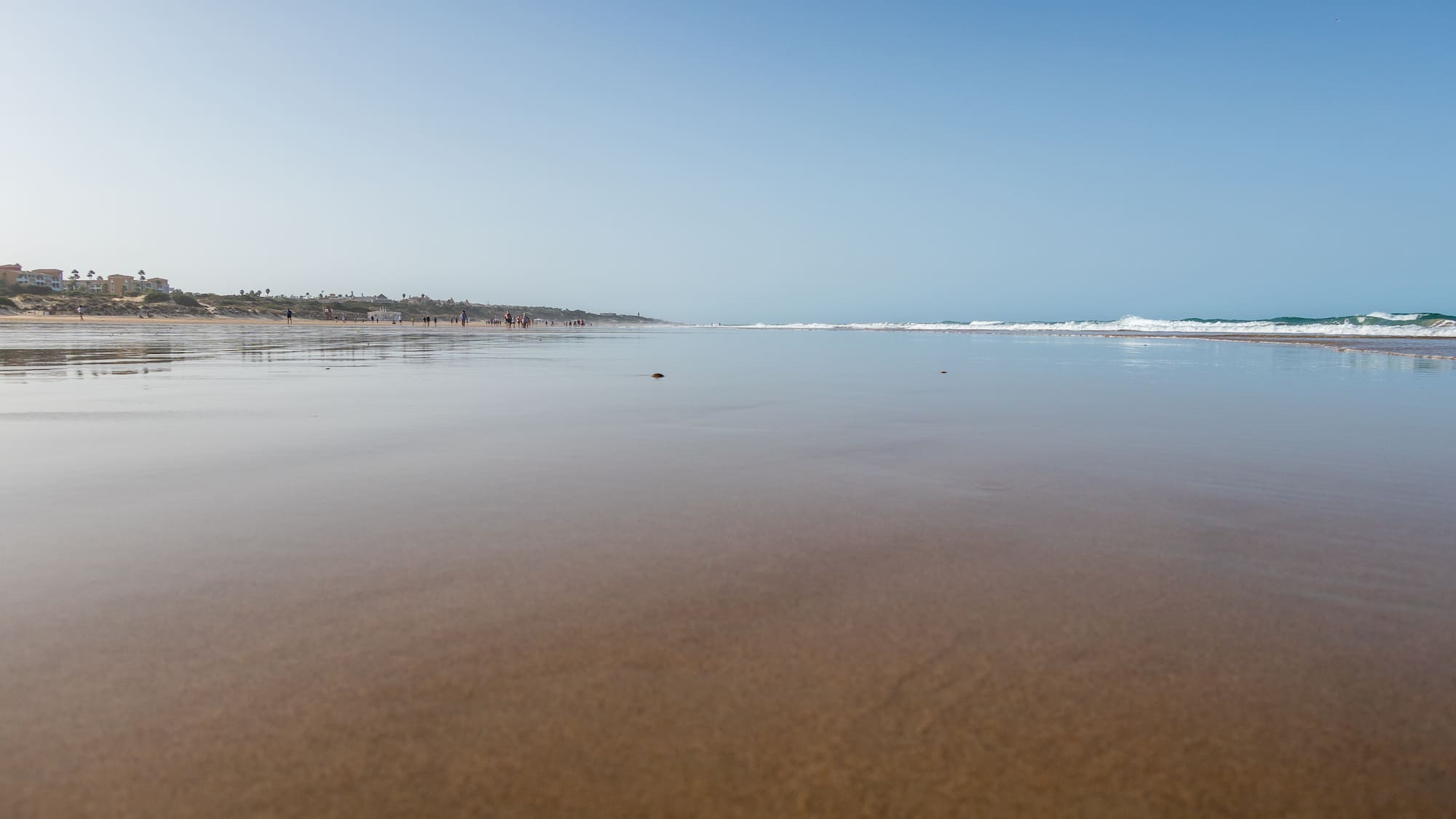 a beach with water and people