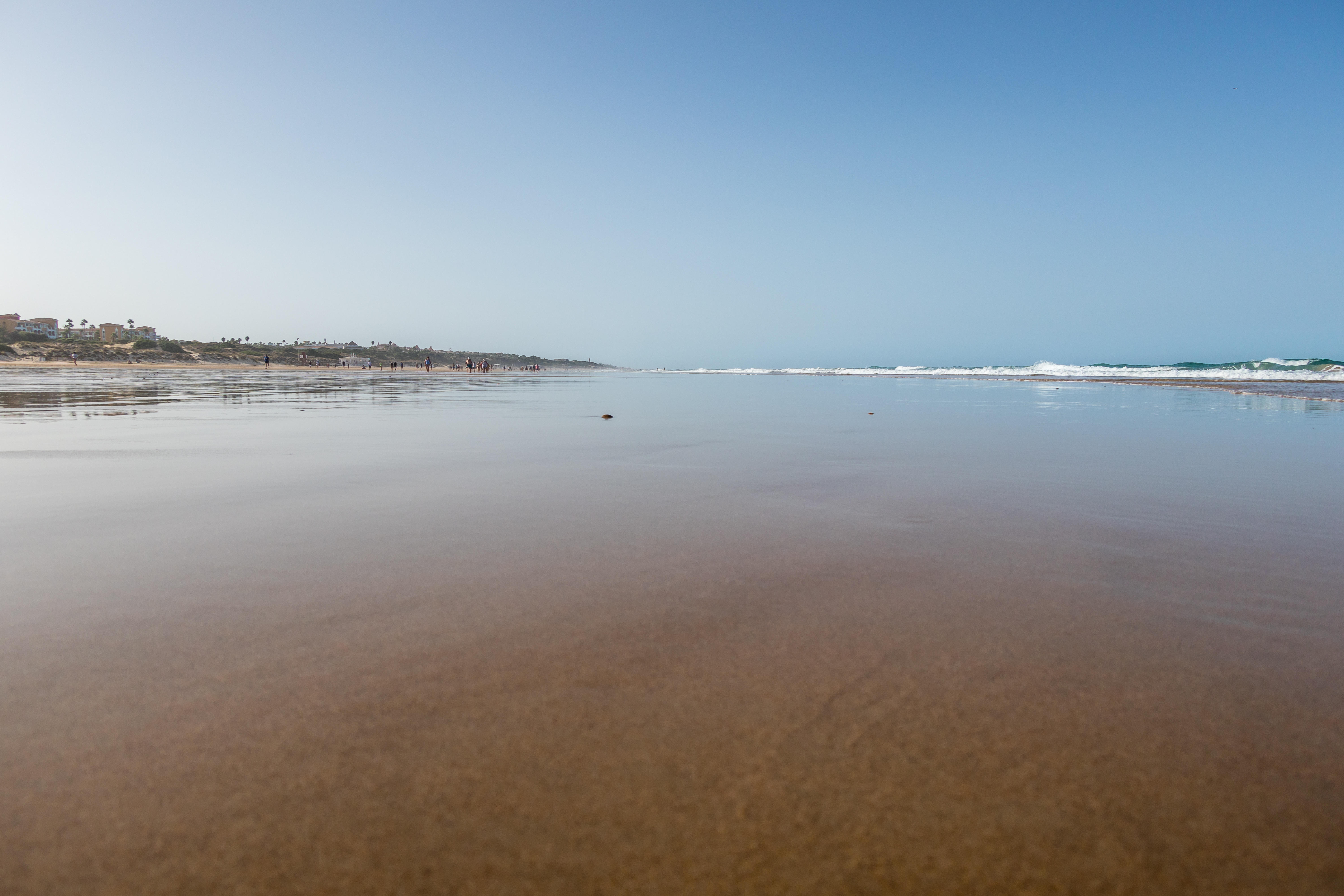 a beach with water and people