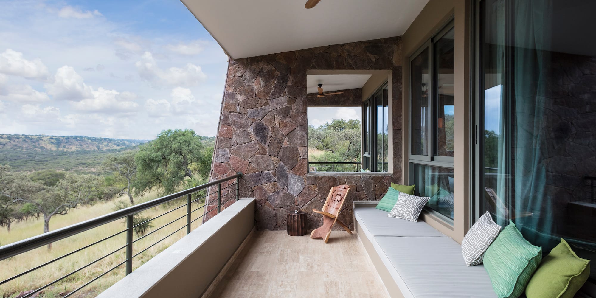 a balcony with a bench and a fan