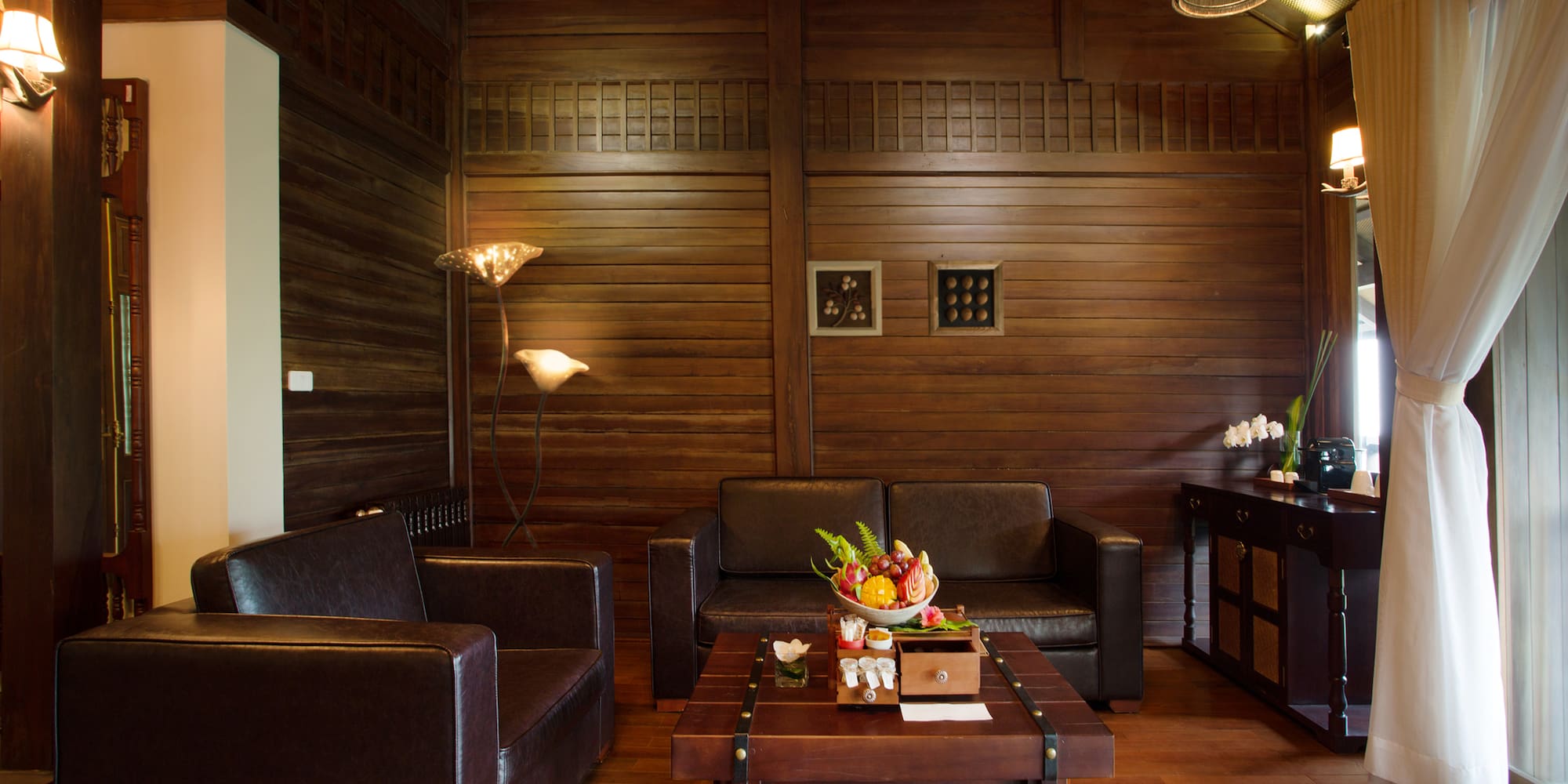 a room with a wood wall and a couch and a coffee table