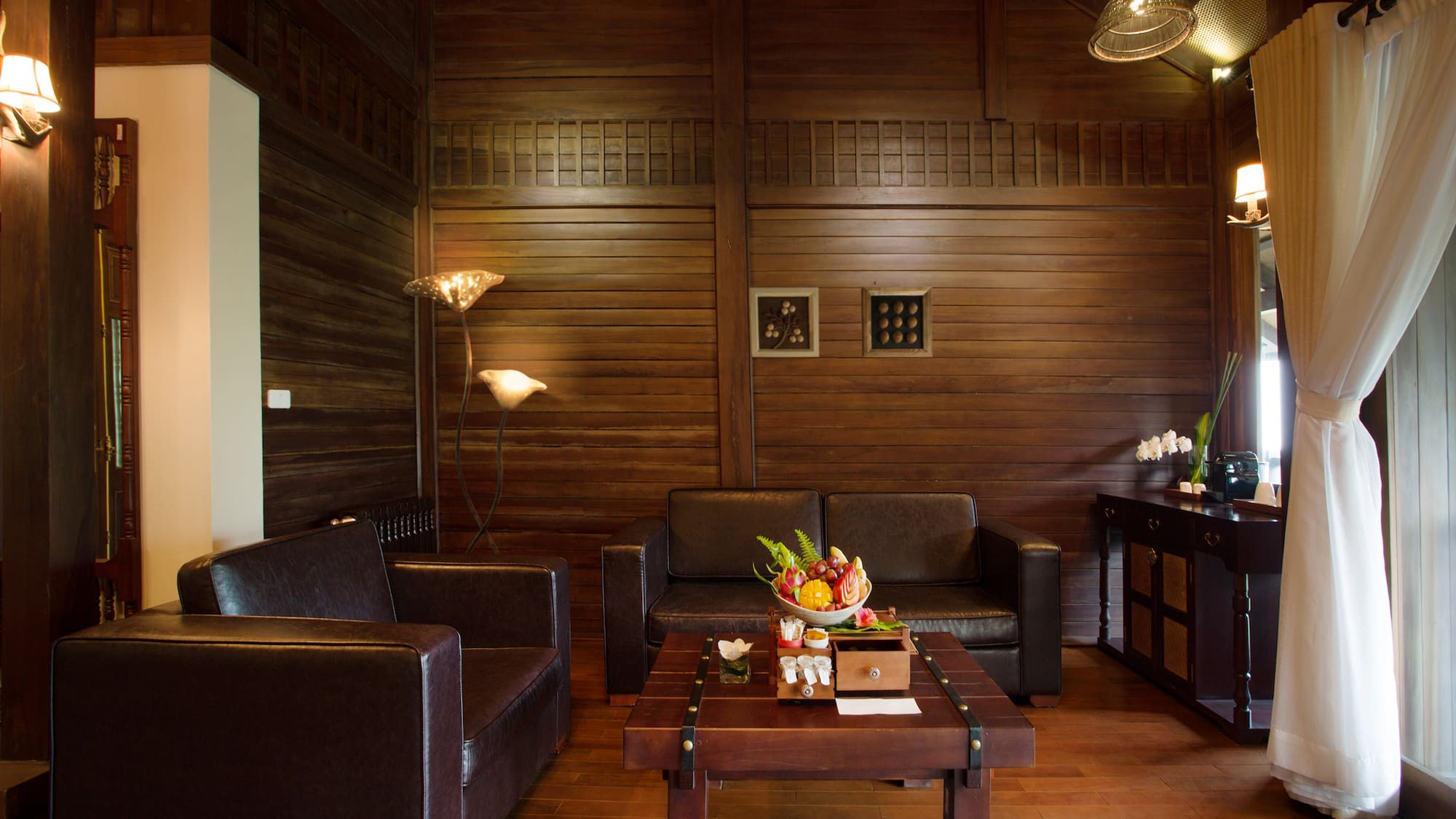 a room with a wood wall and a couch and a coffee table