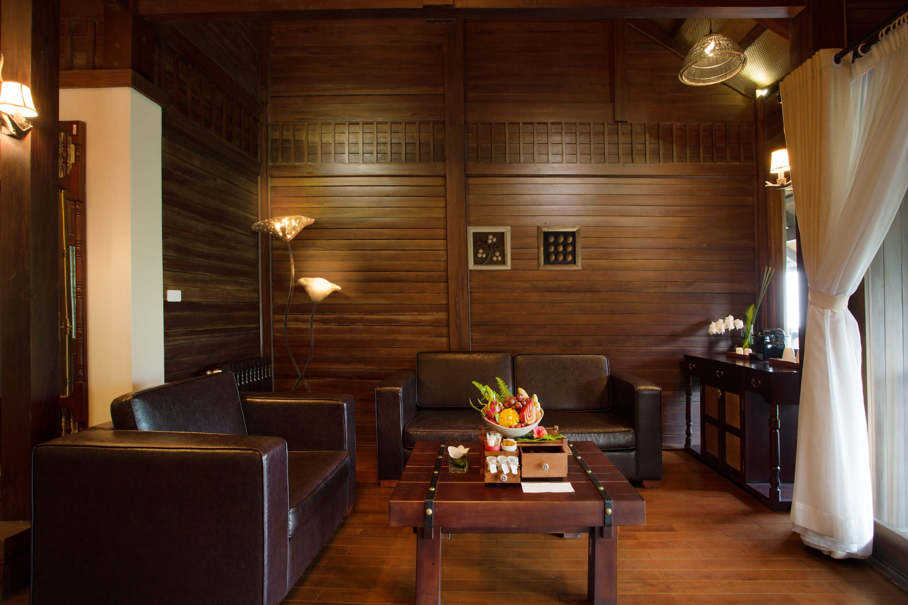 a room with a wood wall and a couch and a coffee table