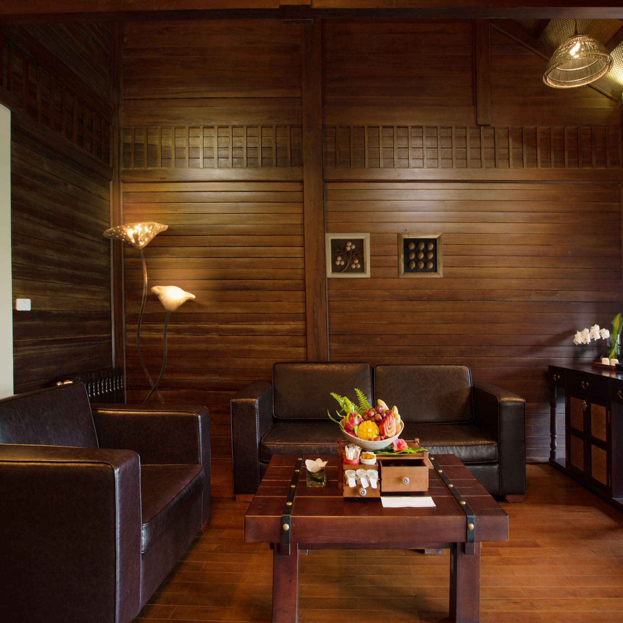 a room with a wood wall and a couch and a coffee table