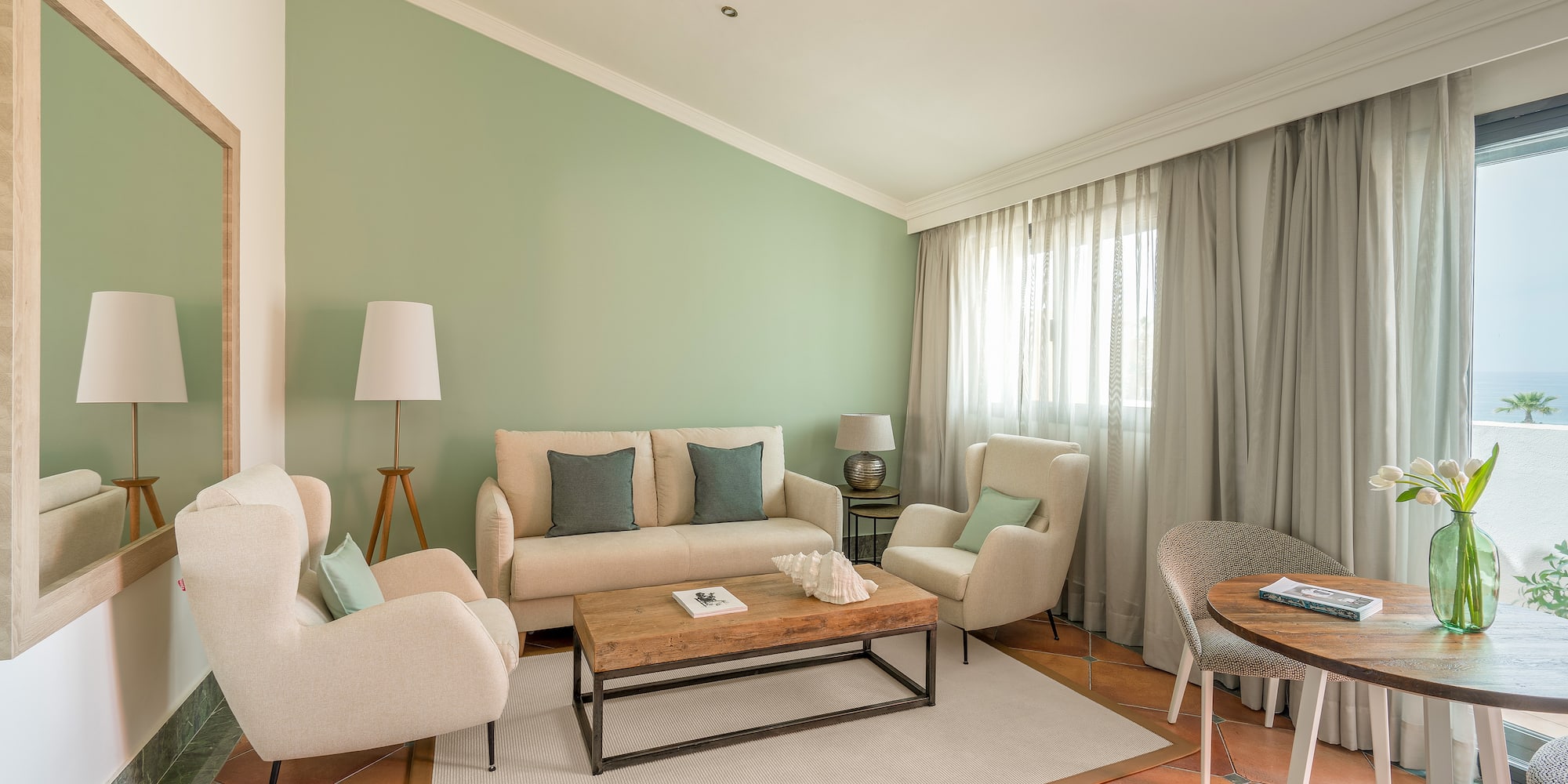 a living room with a couch and chairs