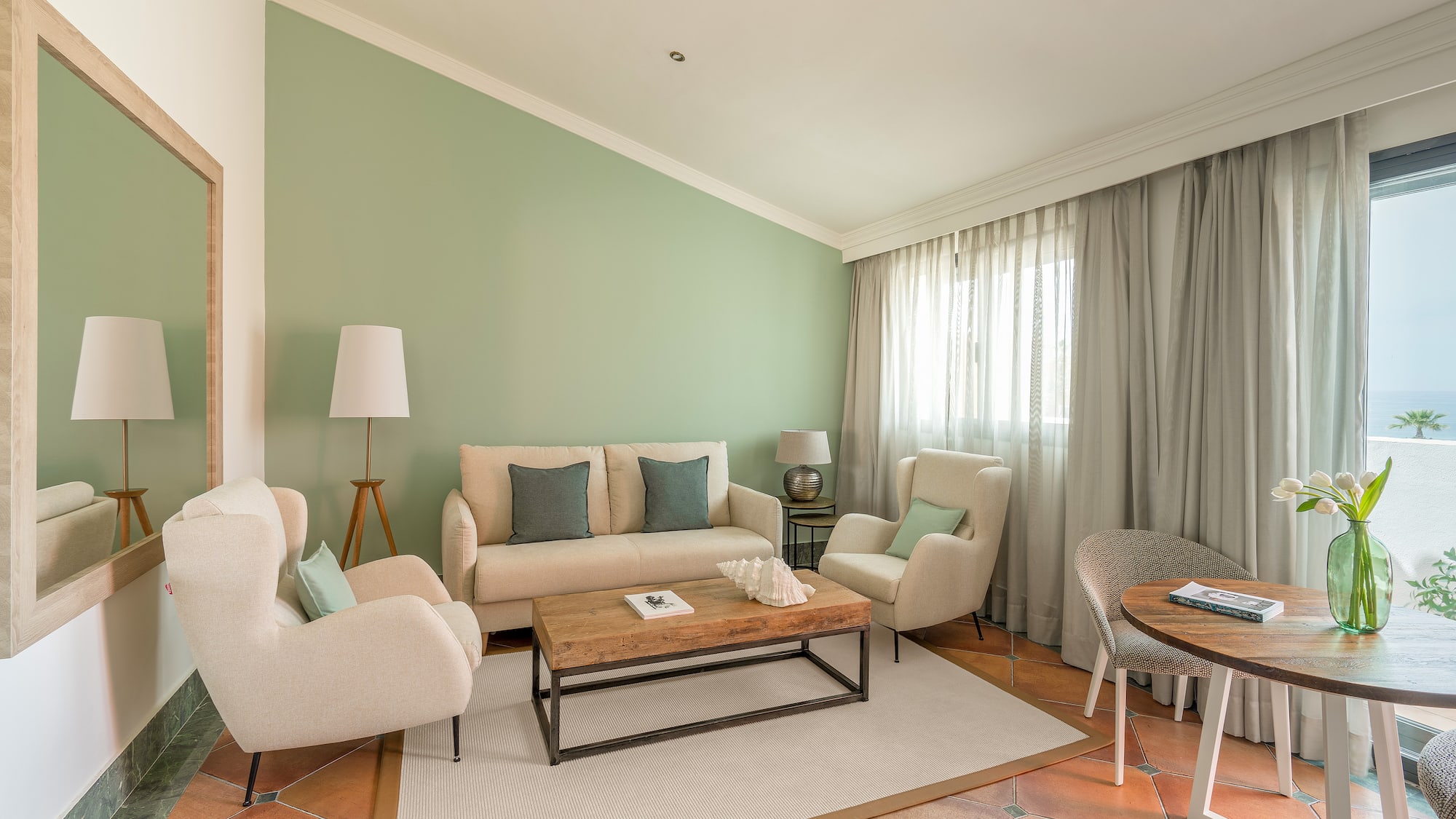 a living room with a couch and chairs