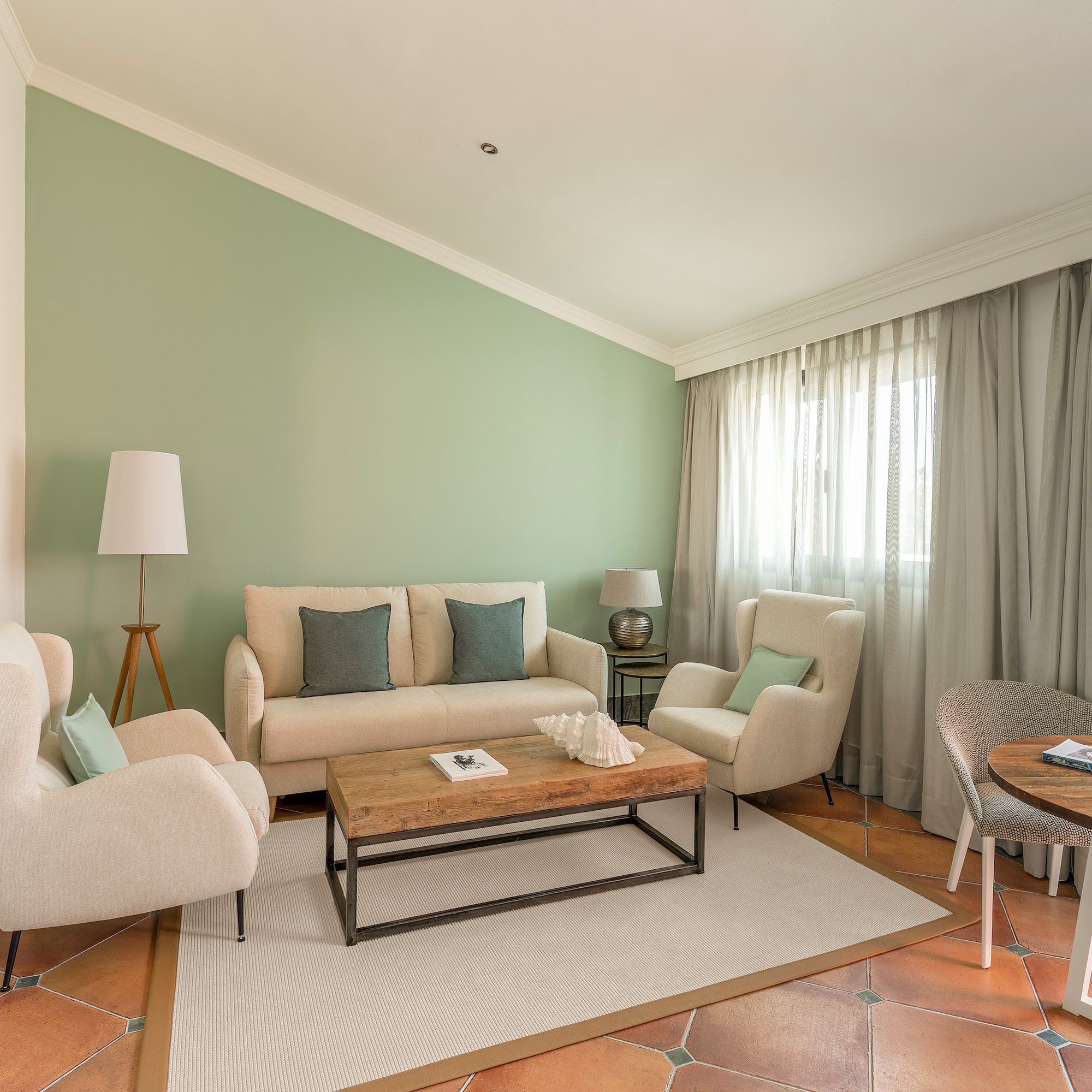 a living room with a couch and chairs