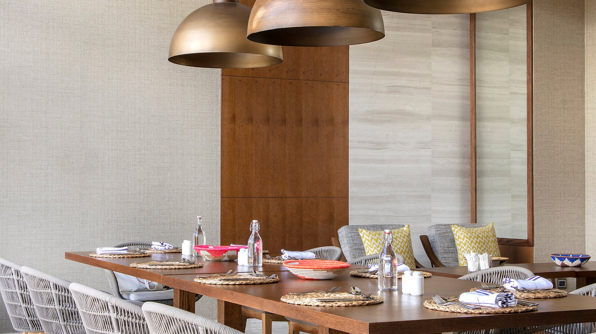 a dining table with chairs and a large chandelier