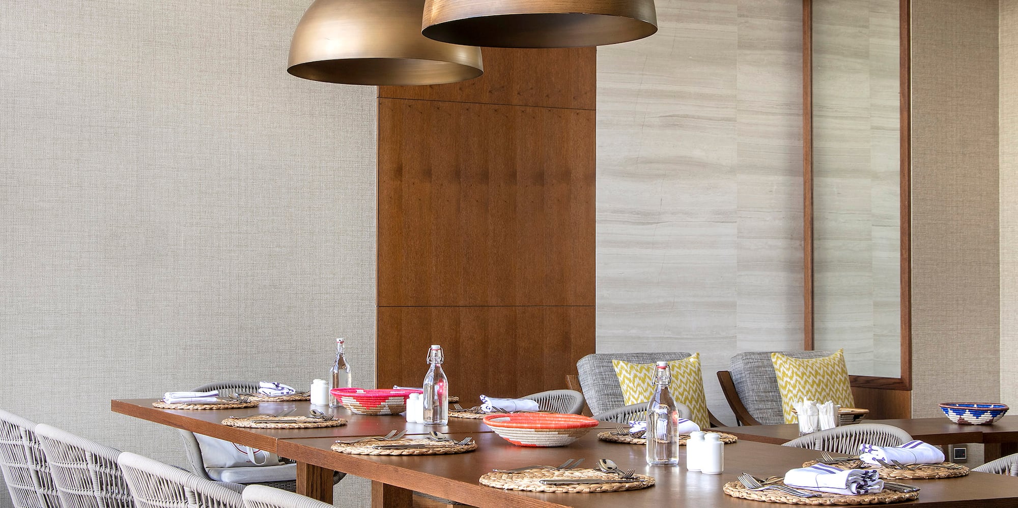 a dining table with chairs and a large chandelier
