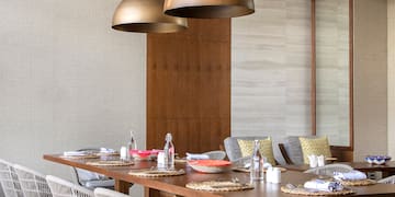 a dining table with chairs and a large chandelier