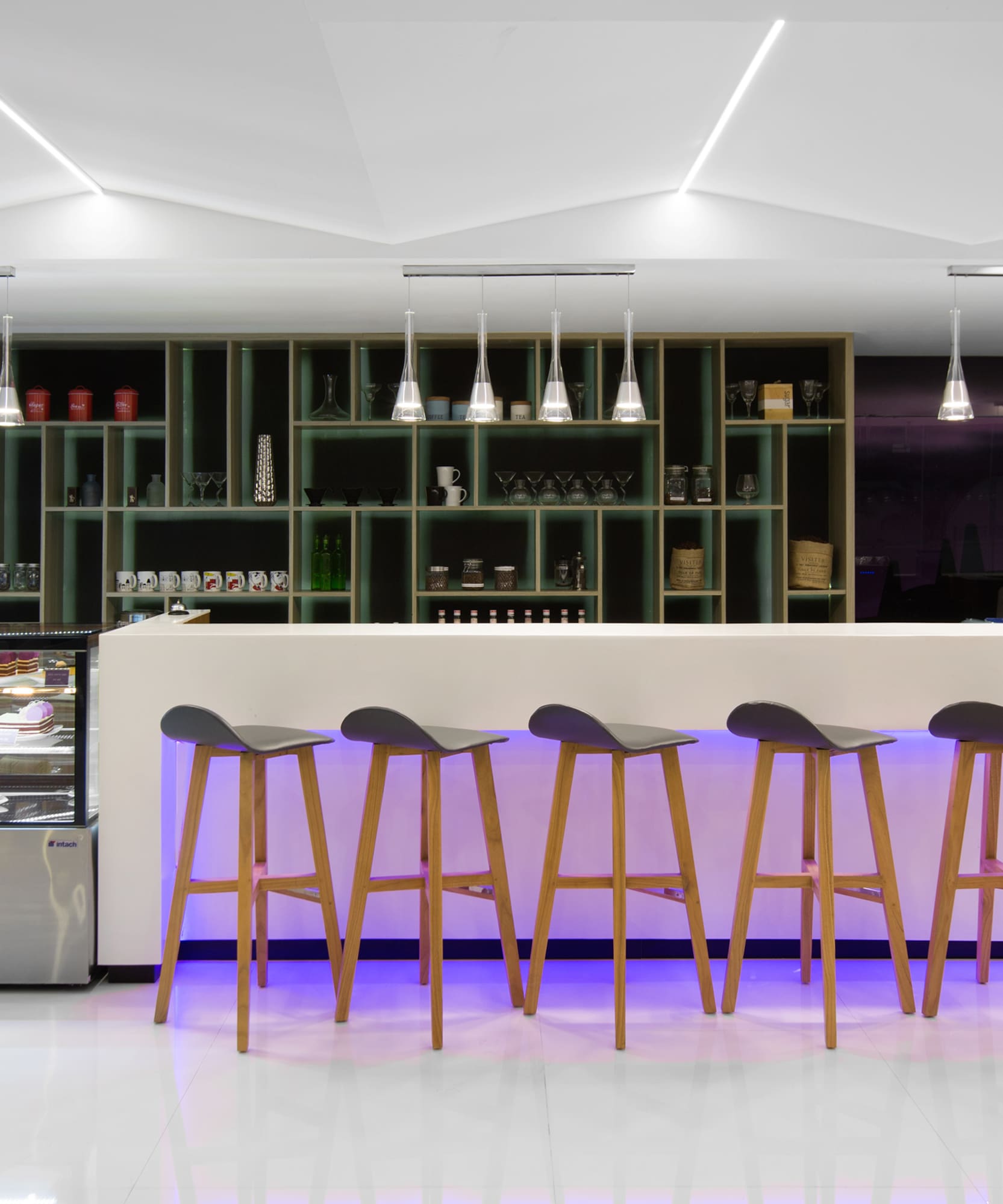 a bar with stools in front of a counter