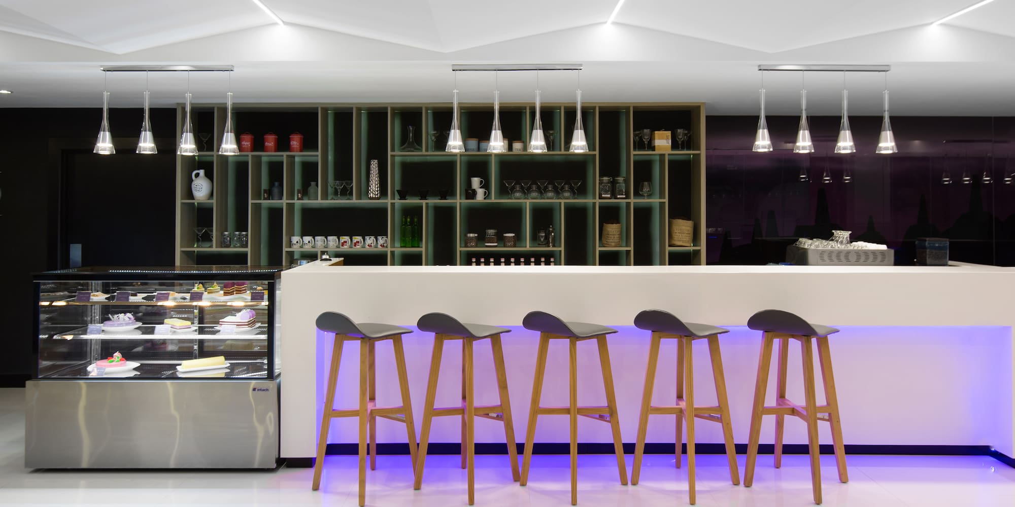 a bar with stools in front of a counter