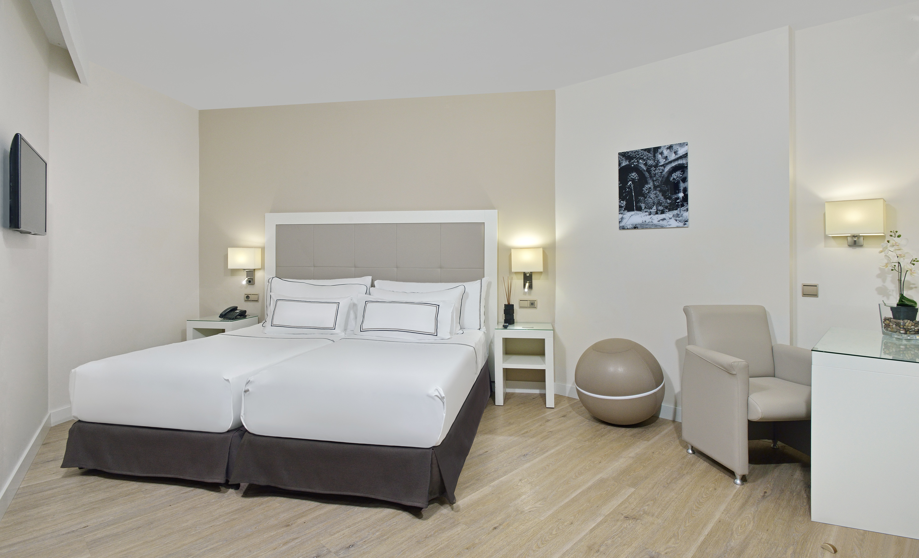 a room with a bed and chairs